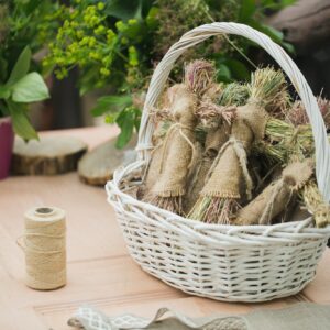 Handmade doll of burlap in the basket on the table